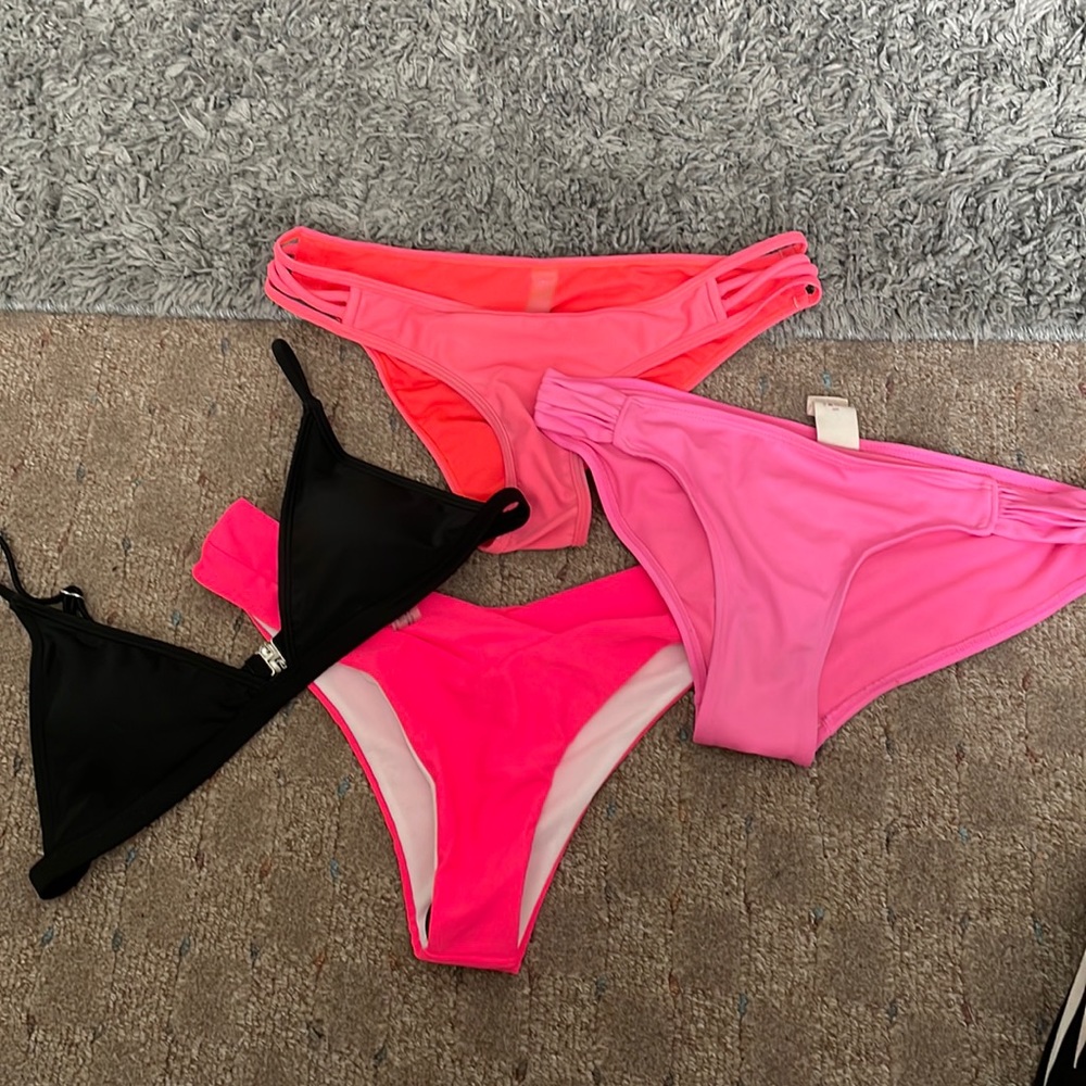 Pink swimming suit bottoms and one black top